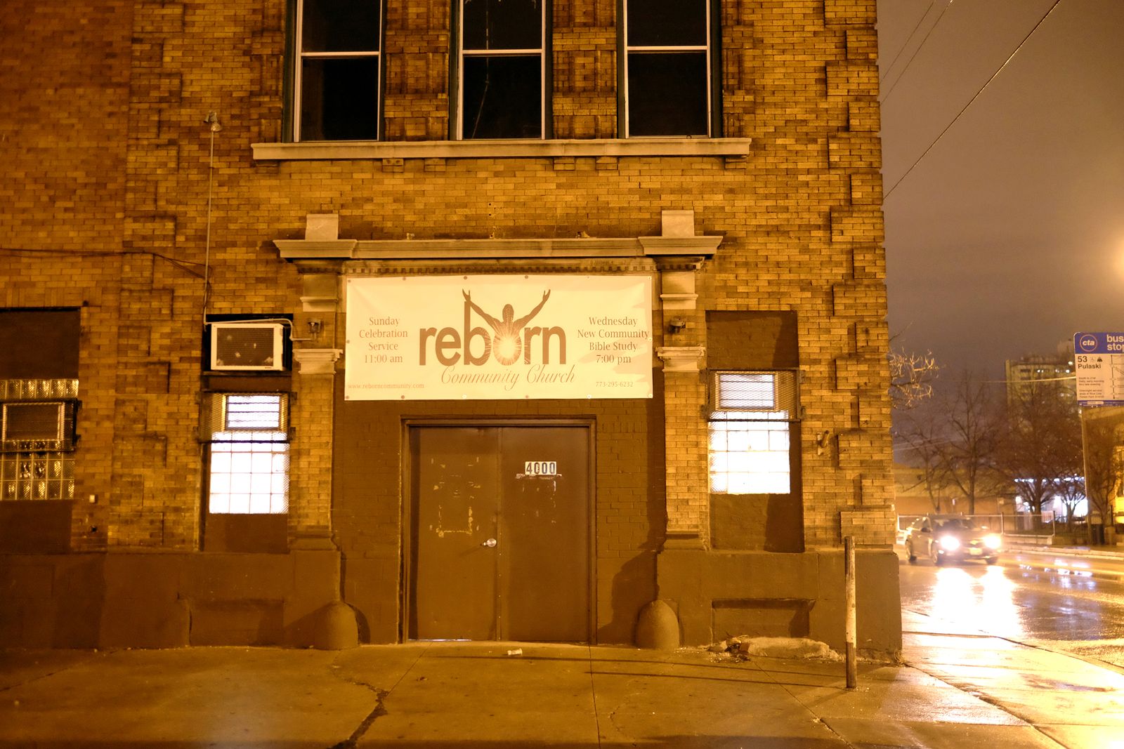 The Reborn Community Church building lit up at night on Pulaski
