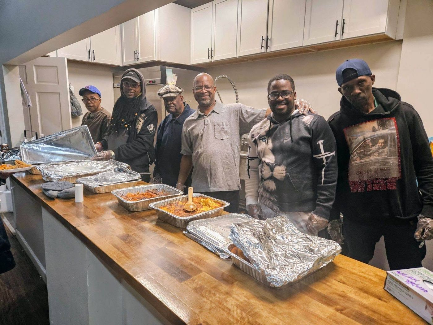 Volunteers serving a hot meal from the church kitchen