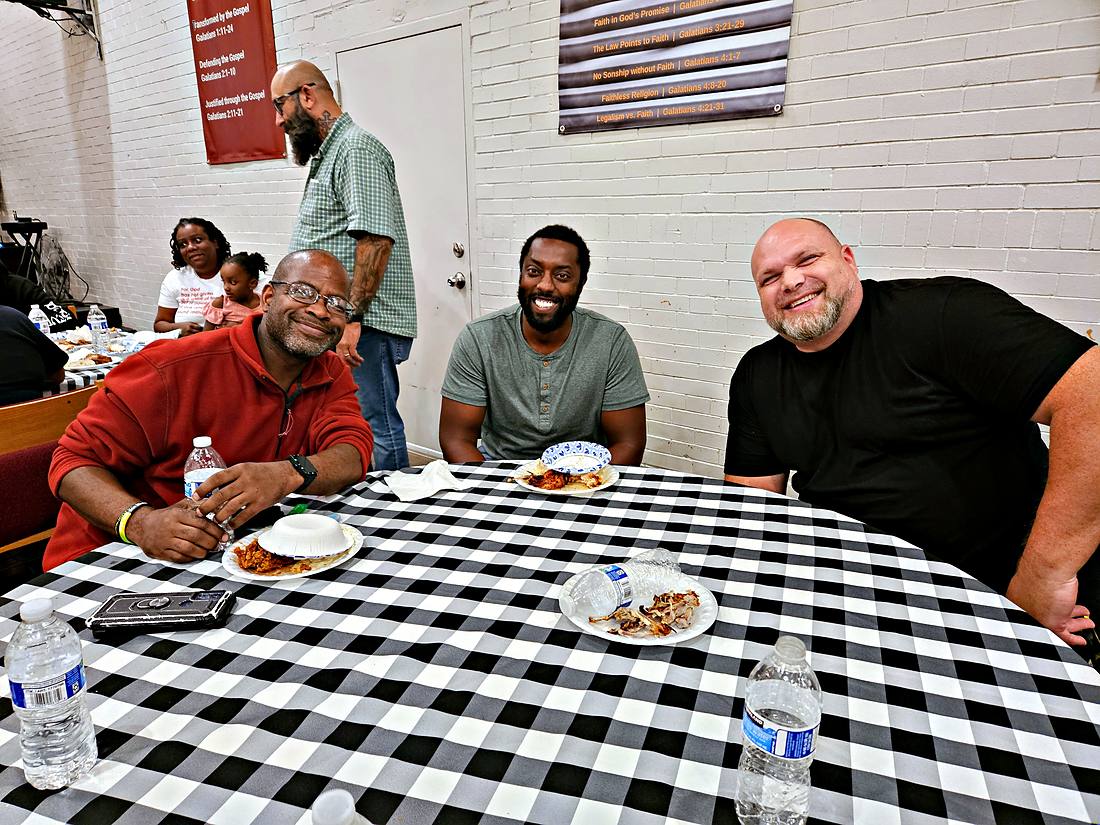 A group sitting around a table together over a meal