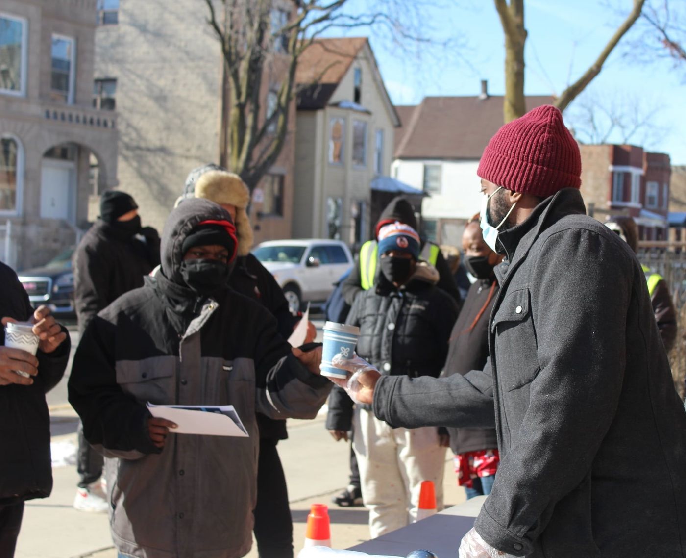Church volunteers handing out supplies to neighbors on the block in winter