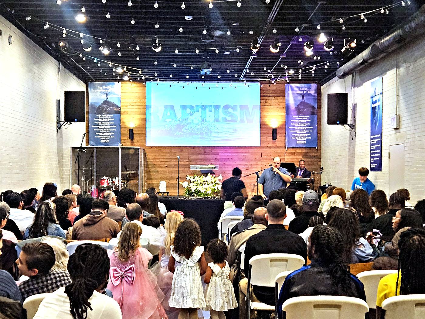 The room full on a Sunday morning, seen from the back of the congregation